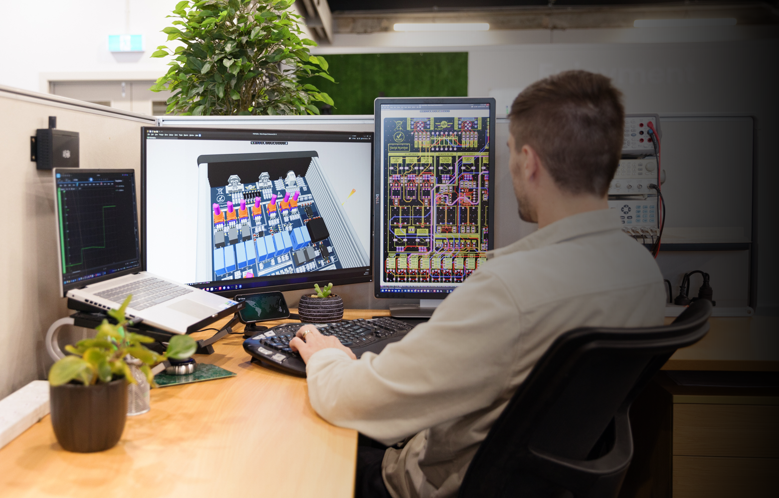 PCB Design engineer working at multi-monitor workstation